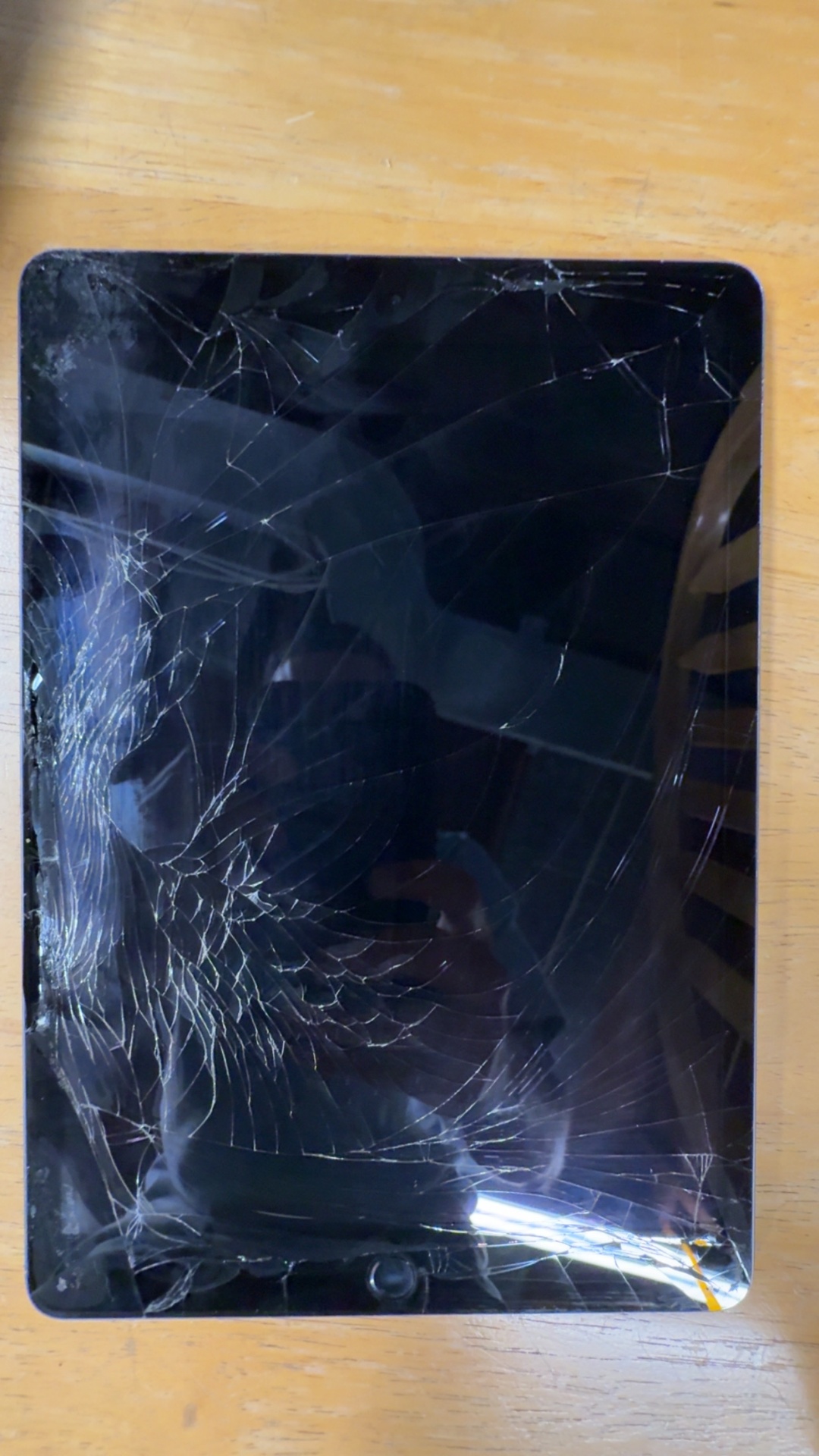 iPad with deeply shattered screen before repair