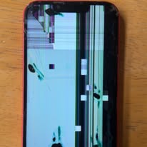 iPhone with shattered, distorted screen before repair